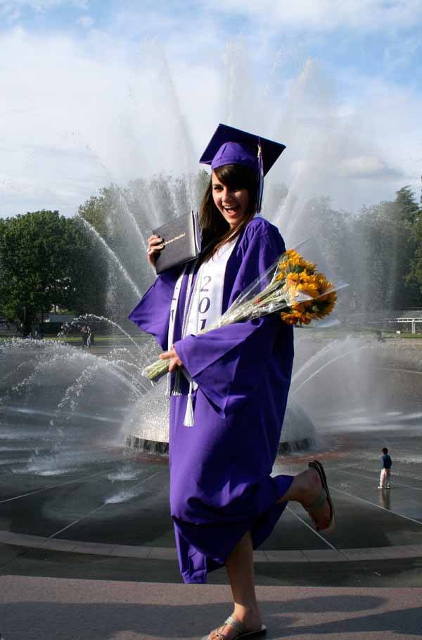 Lake Washington High School graduating senior Meagan Youngers poses for a post-graduation photo for her parents in front of a fountain at the Key Arena in Seattle June 15. For a full listing of all Kirkland high school graduates