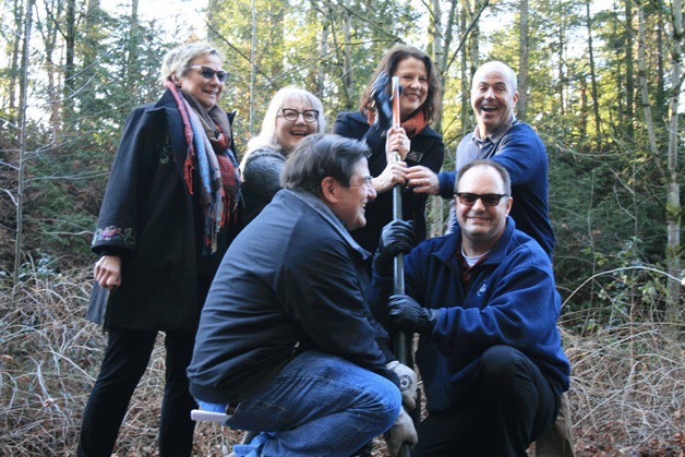 City and regional officials prepare to pull a spike from the old BNSF railroad tracks during a ceremony near the Kirkland and Bellevue boundary on Friday. From left