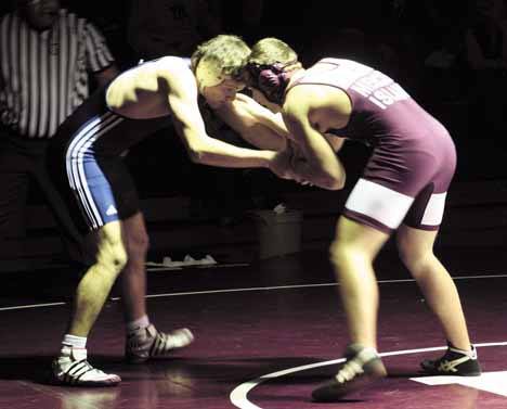 Logan McCallum works on his strategy for beating Mercer Island's Cole Johnson in the 171 weight class during the Rebels loss to the Islanders last Wednesday.