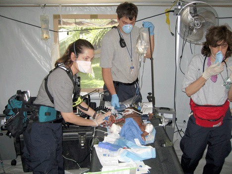 Evergreen Hospital nurse Amanda Cox (left) works to help save a young child during the aftermath of the Haiti earthquake.