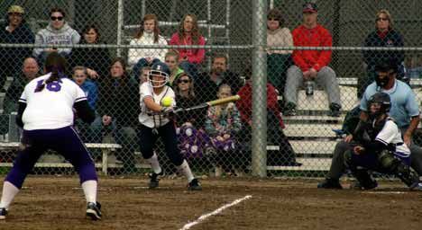 Juanita batter L. Faist hits the ball down the third base line at Emilee Ronbeck of Lake Washington