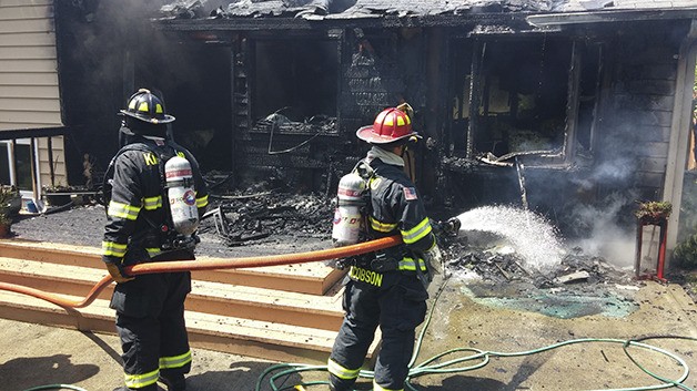 Kirkland firefighters put out the flames at a house fire near 132nd Square Park in the Evergreen Hill neighborhood.