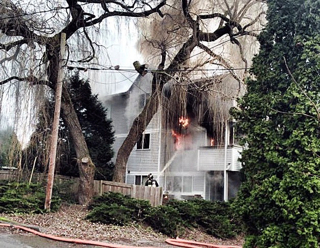 Firefighters from Kirkland and Bothell attempt to put out a blaze at a Finn Hill apartment in Kirkland on Jan. 2.