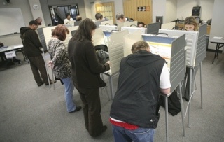 Voters fill a row of booths while voting at Kirkland City Hall during the election on Tuesday