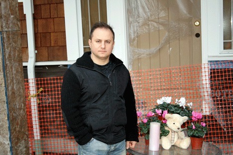 Leonid Milkin stands in front of his partially rebuilt Kirkland home on Slater Avenue. The house was burned down three years ago by Conner Schierman