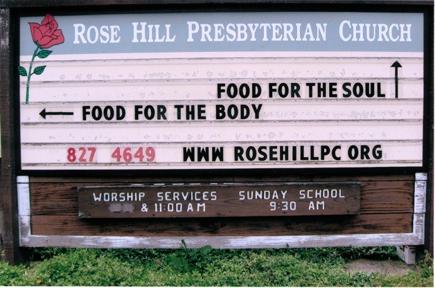 A sign for Rose Hill Presbyterian Church shows the building's relation to the nearby Costco store.