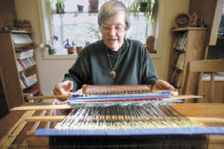 Kirkland resident Jan Paul works on a project with her loom at her home on Feb. 13. Paul is a hand weaver of Saganishiki