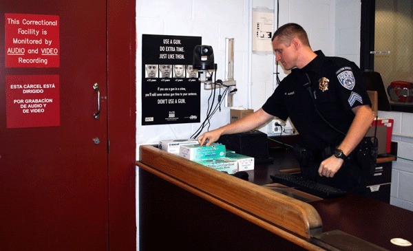 Capt. Kevin Florence at the check-in desk in the current Kirkland city jail. The jail has 12 beds and expansion of the facility in the new Public Safety Building is an issue that could save the city money in the long term but will cost more to build for larger capacity.