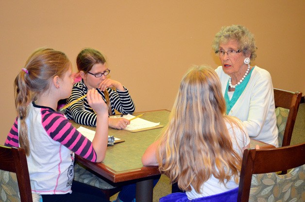 Students from Lakeview Elementary spend time with a resident at Merrill Gardens senior living center.