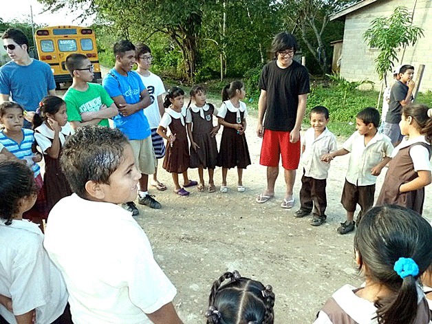 PSAA students singing with the young students of Bullet Tree School.
