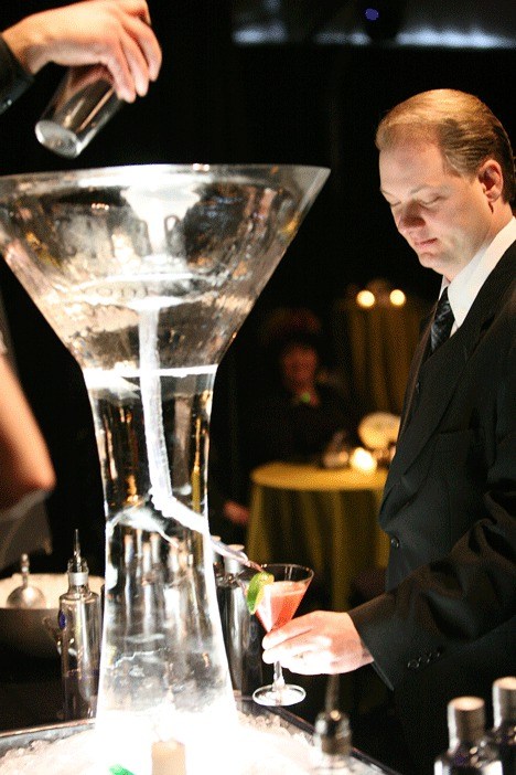 Mike Swenson holds a glass under a spout and waits while his drink is delivered through an ice sculpture during the Annual Evergreen Gala at Marymoor Park in March 2009.