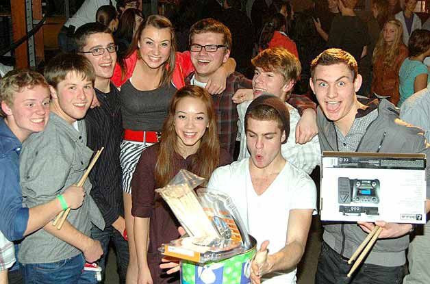 Local teen band members show off their prize packages during the One Song