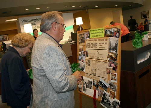 C.C. Schott; former manager of Washington Federal in 1955; looks at some memorablia with wife; LaVonne; during the bank’s grand re-opening on Sept. 23. The bank is located at 116 Kirkland Ave.
