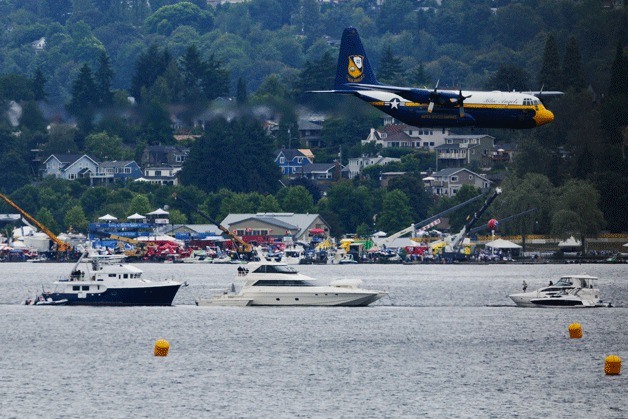 The U.S. Navy Blue Angels support aircraft 'Fat Albert' makes a pass during practice of a 'flat' performance routine under gray skies over Lake Washington in this view from the Interstate 90 bridges deck on Friday.