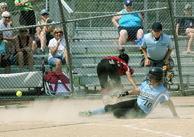 Kirkland's Abby Anthis scores on a close play a the plate. Anthis was struck on the elbow by the throw to the plate just before scoring.