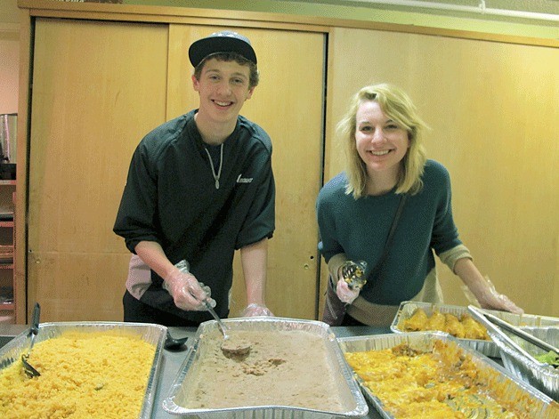 Philip Roe and Stephanie Tilden volunteer to serve food at an Eastside shelter.