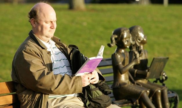 Don McDaniel sits in the sun as he reads at Houghton Park in year's past.