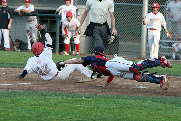 Kirkland resident Andy Cosgrove dives to make the tag on a Mount Si player during the 2014 Juanita High School baseball postseason.