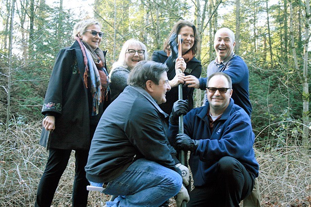 Kirkland city officials and representatives remove a rail road spike from the old BNSF rail line at the Kirkland and Bellevue boundary on Friday.