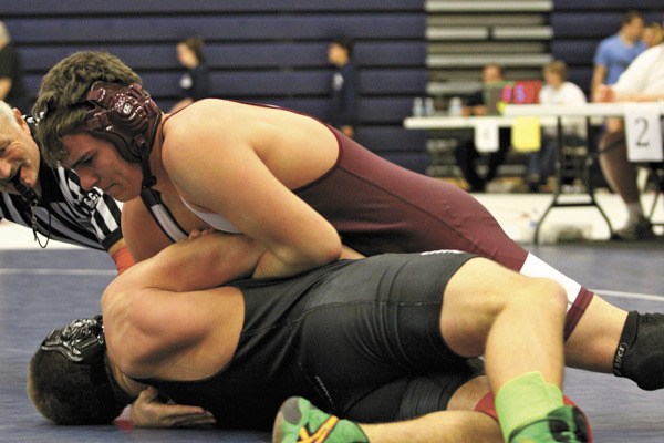 Mercer Island's TJ Blackburn wrestles Lake Washington's Jack Michels during the regional tournament last weekend. Michels is one of three Kang wrestlers competing in this weekends state tournament.