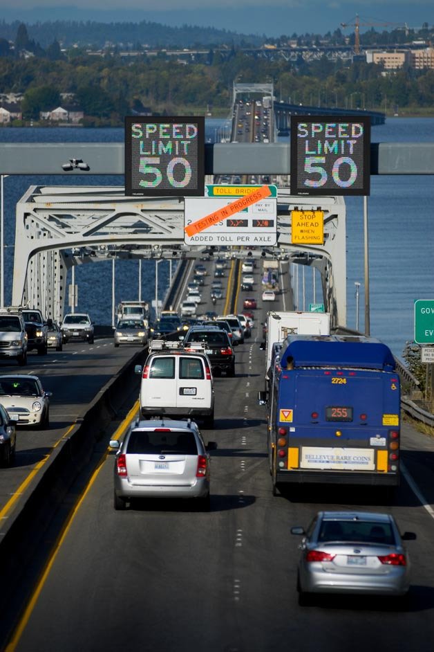 Signs denoting toll testing in progress over the westbound lanes of the SR 520 floating bridge in Medina on Sept. 23. Tolling is set to start in December