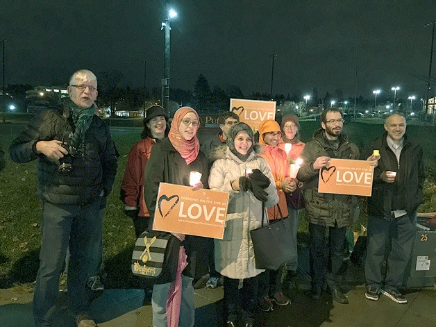 People of all backgrounds gathered along Central Way in Kirkland for an inter-faith peace vigil in support of Syrian refugees.