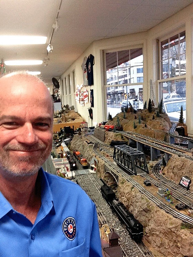 Lionel Trains representative Rudy Trubitt stand next to Eastside Trains big display in the downtown Kirkland store.