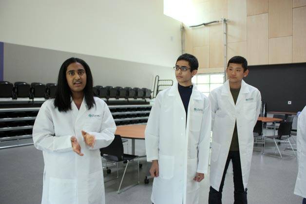 Sophomore Maya Ganesan (left) shares some of the things she enjoys about Lake Washington School District’s new STEM School as Devansh Kukreja and Kevin Nakahara look on.