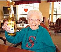Mary Fowler enjoys a beer for her 100th birthday Feb. 6 at The Gardens at Juanita Bay.