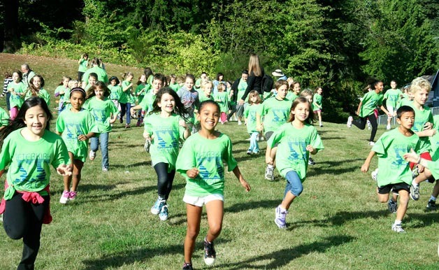 About 600 Peter Kirk Elementary students run around the school's field during the annual Fun Run on Friday. The event raised more than $47