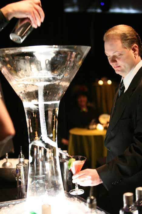 Mike Swenson holds a glass under a spout and waits while his drink is delivered through an ice sculpture during the Annual Evergreen Gala at Marymoor Park last year.