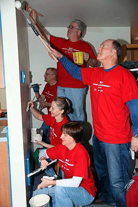 Volunteers help paint the interior of Friends of Youth apartments during the Master Builders Care Foundation's 7th Annual Paint a Better Tomorrow event.