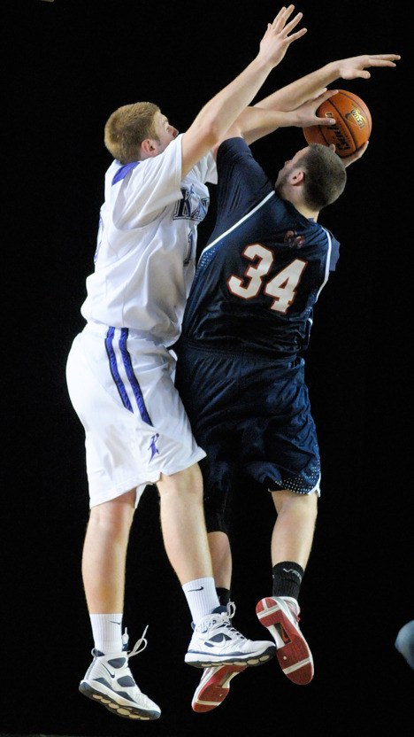 Lake Washington's Matt Hill blocks the shot of his opponent during the first round of the state tournament Wednesday at the Tacoma Dome.