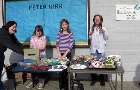 Fourth grade Girl Scouts from Peter Kirk Elementary conduct a benefit bake sale for Haiti’s earthquake victims at school last week. The troop raised more than $200. Leftover baked goods were donated to the Goodwill’s job training center in Bellevue.