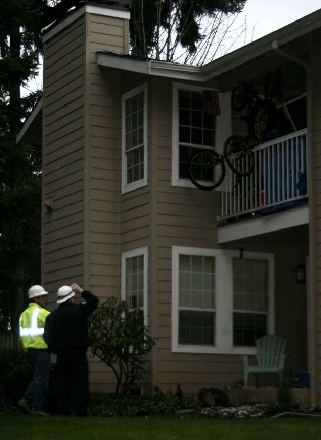 Fire investigators survey the damage from an explosion and fire in December of last year.