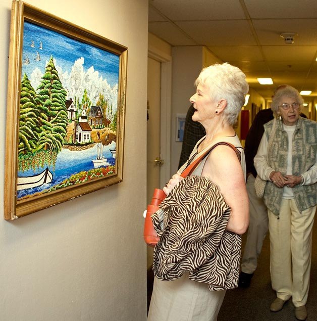 Art show patron Shirley Ward of the Kirkland Woman’s Club views a painting during the 'Every Picture Tells a Story' senior art exhibit at Evergreen Hospital. The painting is by Kazuhisa Kashiwaya