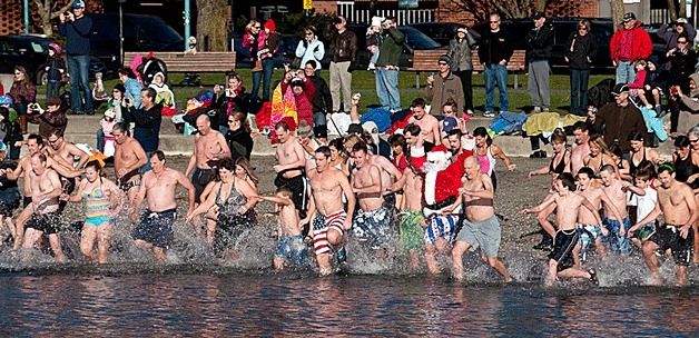 A crowd of people dash into Lake Washington's freezing water for the unofficial Polar Bear Plunge to ring in the New Year on Jan. 1 at Marina Park.