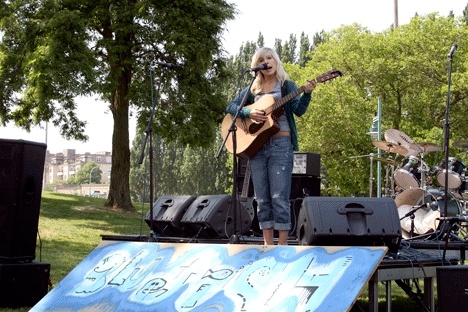 Artist Rachel Wiegand of Mukilteo plays an acoustic set during the Blue Fish Festival Saturday.