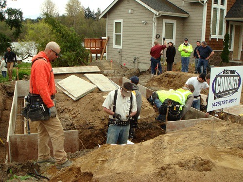 Community members donate their time to help rebuild Leonid Milkin's garage.
