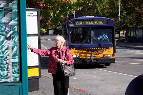 A Metro bus rider checks the schedule at Kirkland’s downtown Transit Center.