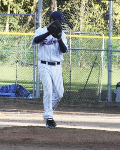 Juanita senior Tyler Kurfess prepares to send a pitch to Mercer Island during the Rebels loss to the Islanders on Thursday.