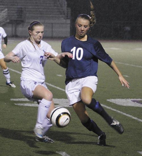 Lake Washington's Sara Crauer (7) battles for the ball against a Bellevue player during the Kangs KingCo tournament championship game. Lake Washington won 1-0 to advance to play a Metro team on Saturday