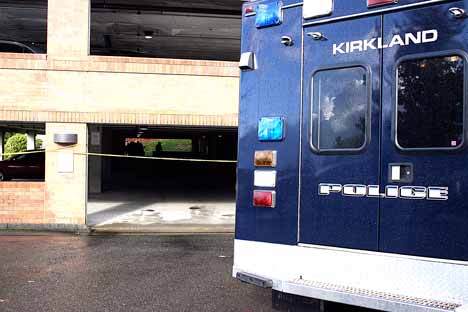 Kirkland police search the Gateway building's parking garage for evidence following a stabbing during the late morning hours on Friday.