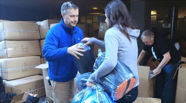 Sleepless in Seattle volunteers prepare to distribute sleeping bags