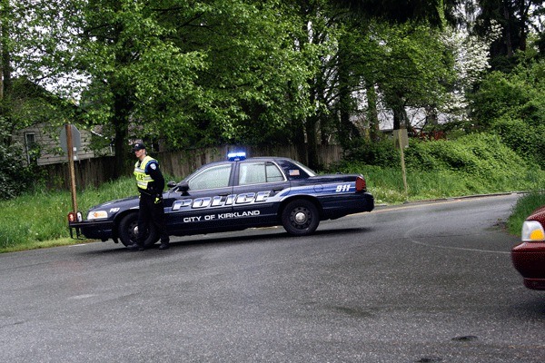 A Kirkland police officer stands guard at the intersection of N.E. 134th Street and 90th Ave. N.E. due to an accident on the busy thoroughfare.
