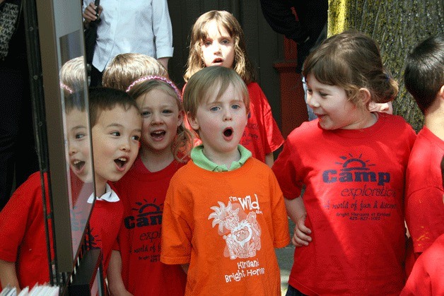 Youngsters from Bright Horizons at Kirkland child care sing 'Apples and Bananas' to kick off the 2012 season of the Kirkland Wednesday Market on Park Lane Wednesday.