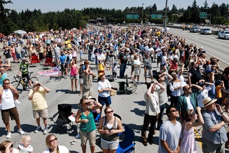 Spectators from around the region gather on the Interstate 90 bridge deck on Mercer Island to watch the Blue Angels practice their aerial performance over Lake Washington on Friday. Seafair will continue through Sunday