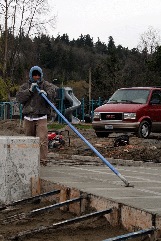 A construction worker levels a new walkway at Juanita Bay Park on March 29 as part of a $2.8 million renovation project. The park
