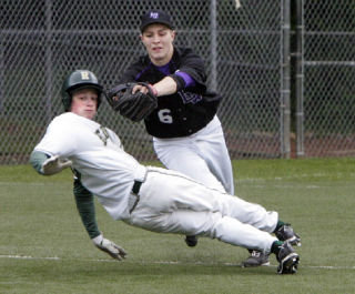 Lake Washington’s Blake Lively (No. 6) chases Redmond’s Tim Wilson (No. 2) down between second and third during the game at Hartman Park last Thursday.