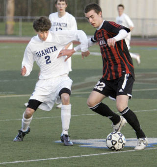 Juanita’s Dane Baird (No. 2) battles with Ballard’s Jacob Byrne (No. 22) for control of the ball during first half action of a game at Juanita High School last Friday. Juanita won the contest 3-0.